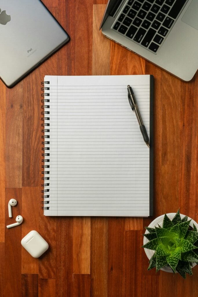 Black pen on white notebook